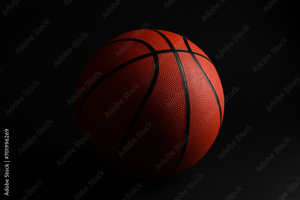 One new basketball ball on black background One new basketball ball on black background