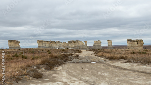 Obraz na plátně chalk rock formation in the missle of a field wit ha dirt road leading to it on