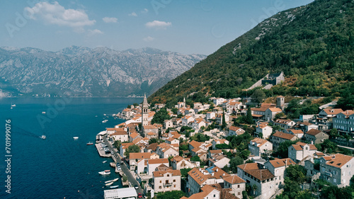 Boats are moored at the piers of the coast of Perast. Montenegro. Drone © Nadtochiy