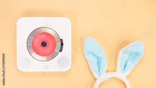 White cd player with red disc with bunny ears on yellow background. Love music, Easter bunny, retro Love song, space for text.