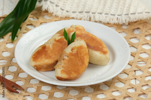 Kue Pukis or pukis cake , Traditional Javanese half-moon shaped pancakes. made from flour eggs yeast and coconut milk.on white background