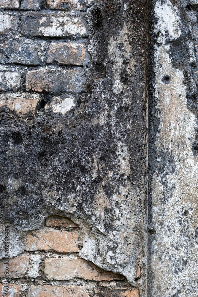 Detail of eroded building wall. Ancient damaged wall.