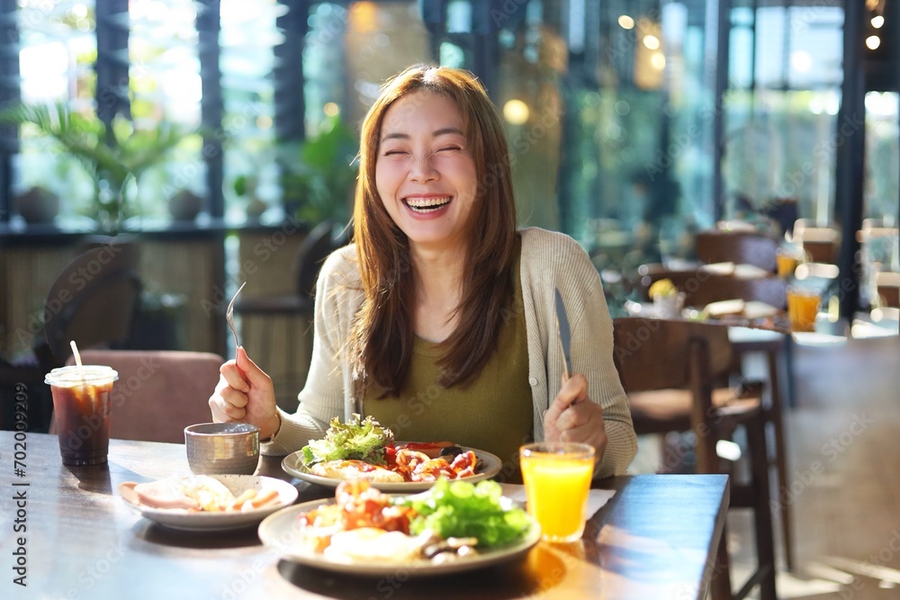 woman eating salad in restaurant