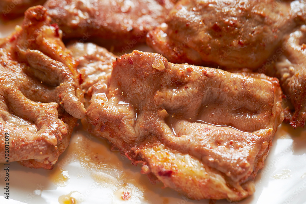 Grilled beef intestines on a plate Grilled beef intestines on a plate