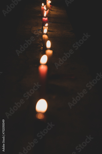 Burning candles on a dark street