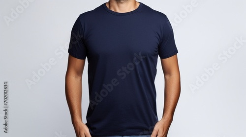 A person in navy blue t shirt on dark white background