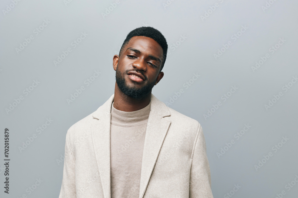 Happy young African American gen z guy isolated on beige background. Smiling hipster ethnic teen student, cool curly ethnic generation z teenager fashion model standing looking at camera, portrait. Happy young African American gen z guy isolated on beige background. Smiling hipster ethnic teen student, cool curly ethnic generation z teenager fashion model standing looking at camera, portrait.