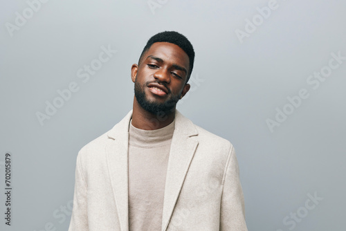 Happy young African American gen z guy isolated on beige background. Smiling hipster ethnic teen student, cool curly ethnic generation z teenager fashion model standing looking at camera, portrait. © SHOTPRIME STUDIO