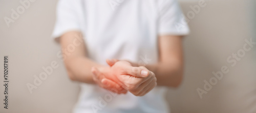 Woman having wrist pain during sitting on sofa at home, muscle ache due to De Quervain s tenosynovitis, ergonomic, Carpal Tunnel Syndrome or Office syndrome concept photo
