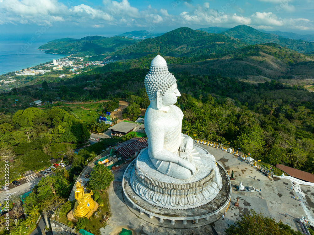 Fototapeta premium aerial photography scenery blue sky and blue ocean behind Phuket white big Buddha..Fog cover Phuket white big Buddha is the famous landmark in Phuket..Aerial panoramic view landscape 