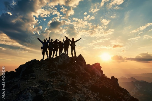 A triumphant group of family members silhouetted on a mountaintop, their hands clasped in unity, symbolizing their collective achievement and the strength found in family bonds. © Lucija