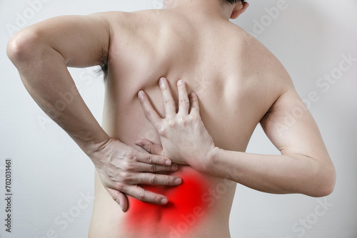 The man's hands were on his waist and back. He has back pain. Health concept