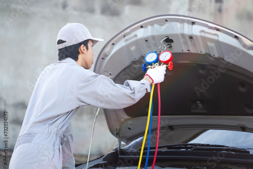 Repairman check and fix car air conditioner system, Technician man checks car air conditioning system refrigerant recharge, Car Air Conditioning Repair
