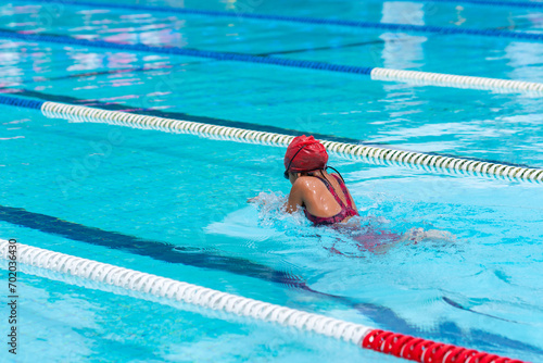 child swimmer swim in swimming pool. Water sports and competition  learning to swim classes for children.