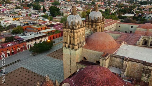 backwards drone shot of Santo Domingo temple in downtown Oaxaca city in Mexico photo