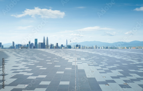 Empty square floor with city skyline