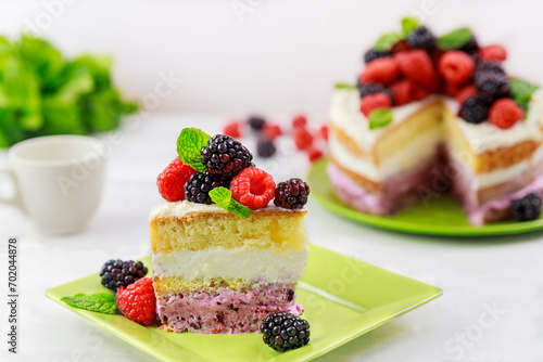 Fresh raspberries and blackberries are used to decorate this homemade berry cake.