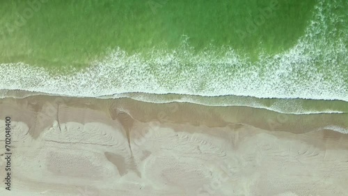 Aquamarine ocean waves gently crashing onto sandy Paternoster beach, top aerial photo