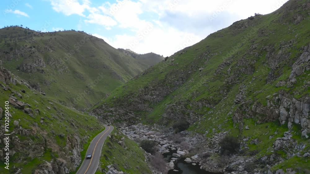 A section of highway nestled deep at the bottom of mountains in Southern California A section of highway nestled deep at the bottom of mountains in Southern California