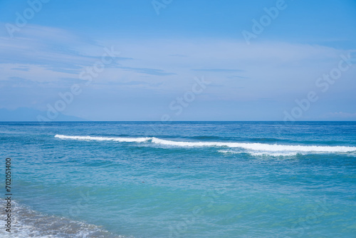 An ideal untouched ocean beach with clear  calm turquoise water.