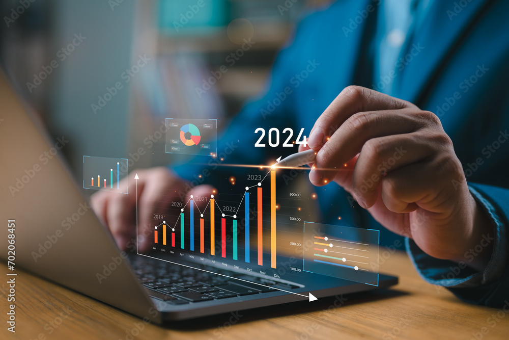 Businessman investor analyzes profitability of working companies with digital augmented reality graphics, positive indicators in 2024, businessman calculates financial data for long-term investments. - obrazy, fototapety, plakaty 