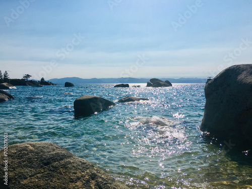 Lake Tahoe Secret Beach blue water rocks and sky shimmering summer day horizon travel  photo