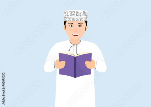 Omani school boy reading a book