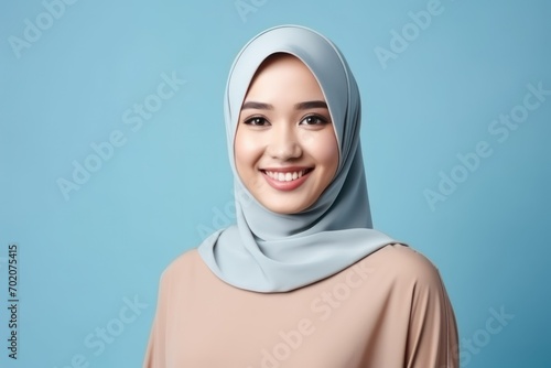 Asian muslim woman isolated blue background photo