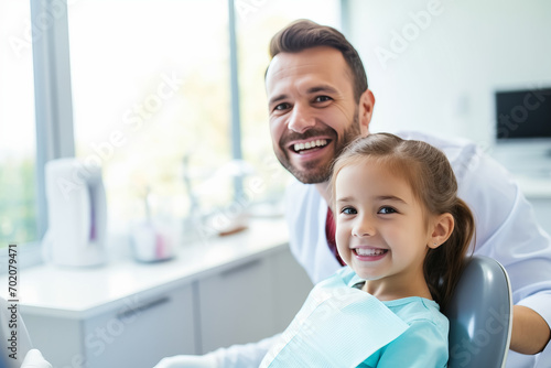 Smiling pediatric dentist with a young patient in dental clinic, Professional stomatology for kid.