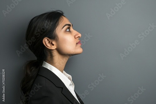 a woman in a suit looking up