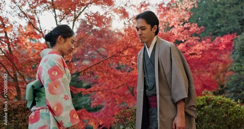 Japanese people in park, bow and traditional clothes with hello, nature and sunshine with respect and culture. Couple outdoor together in garden, greeting with modesty and tradition, polite and kind