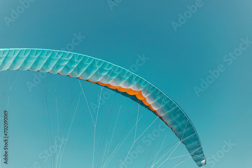 Colorful paraglider close-up against the blue sky © fotomaximum
