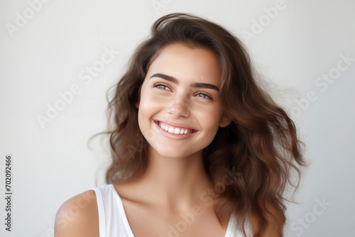 Radiant smile young woman's portrait white background 
