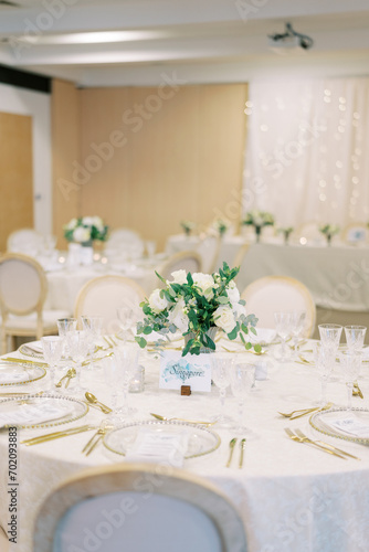 Set festive table with a bouquet of flowers and a menu on plates