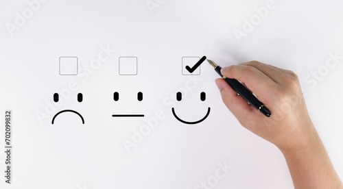 Satisfaction evaluation concept, hand makes like mark on face showing happiness. photo