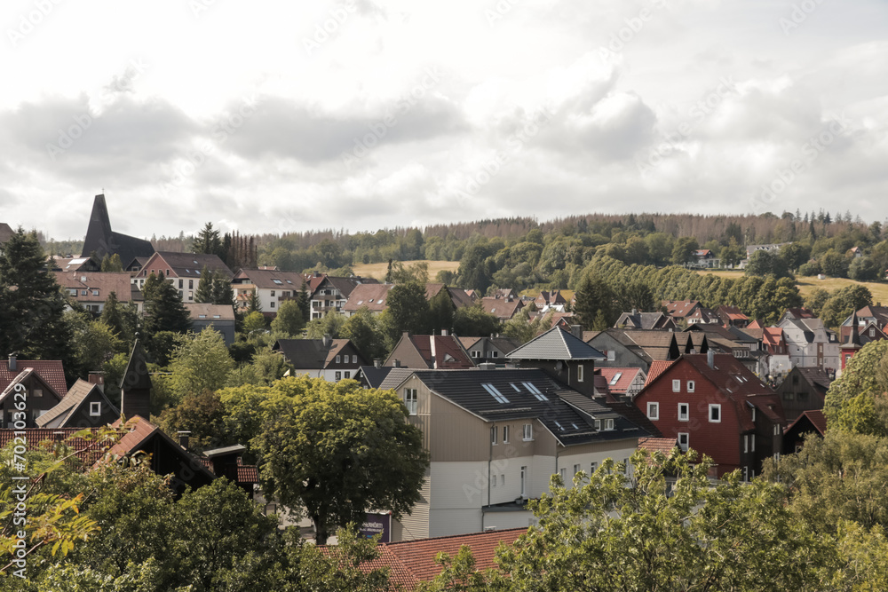 Village with residential houses, vacation homes and apartments. Architecture surrounded by forest, hills nature landscape in Braunlage, Lower Saxony, Germany.