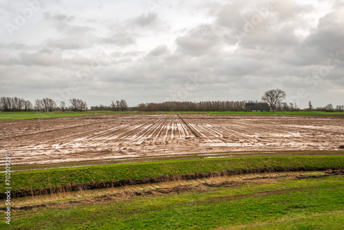 Obraz na płótnie Dutch field after persistent rain. The photo was taken in the province of North Brabant on a heavily cloudy day in early winter. w salonie