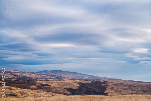 landscape in a hilly area with white clouds.