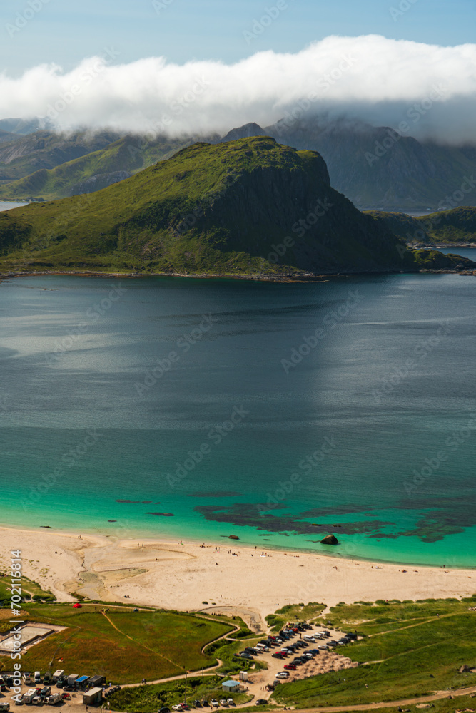 The beach of Hauklandstranda in Lofoten, northern Norway, from above, turquoise sea, white sand, bright sunlight.
