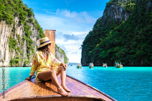 Asian women in front of a longtail boat at Kho Phi Phi Thailand photo