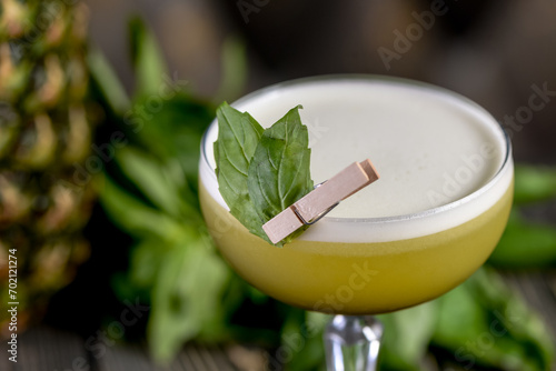 green cocktail on a wooden board with basil leaves macro photo
