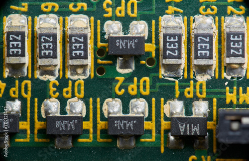 Detail of old electronic components of a motherboard with its chips, capacitors and solders
