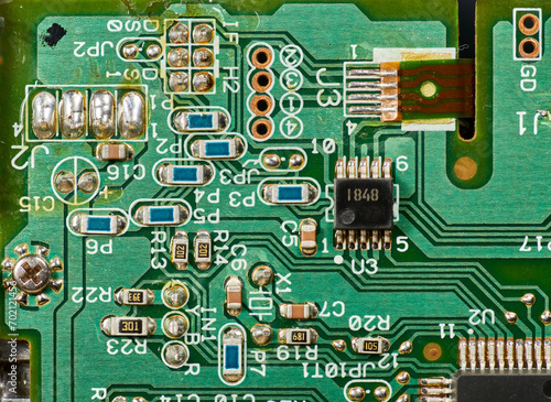 Detail of old electronic components of a motherboard with its chips, capacitors and solders
