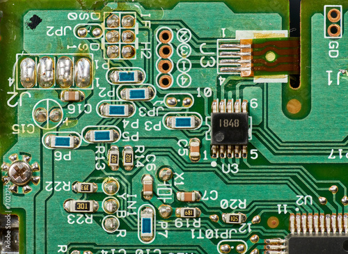 Detail of old electronic components of a motherboard with its chips  capacitors and solders