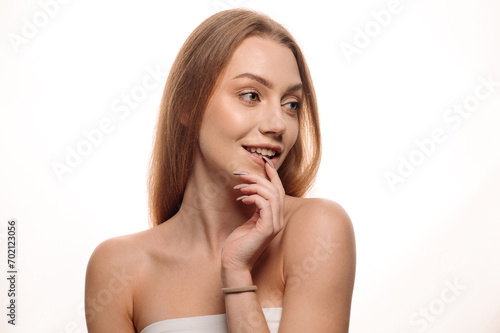 Beauty portrait of a young blonde girl on an isolated white background. Skin care
