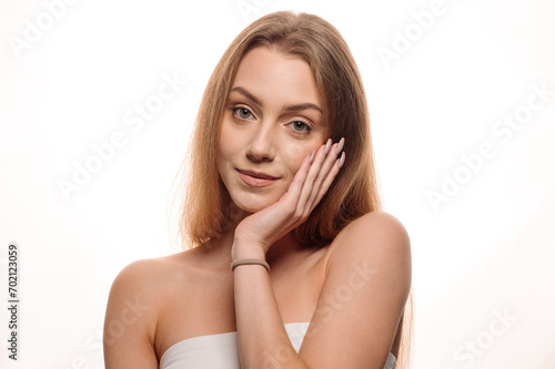 Beauty portrait of a young blonde girl on an isolated white background. Skin care