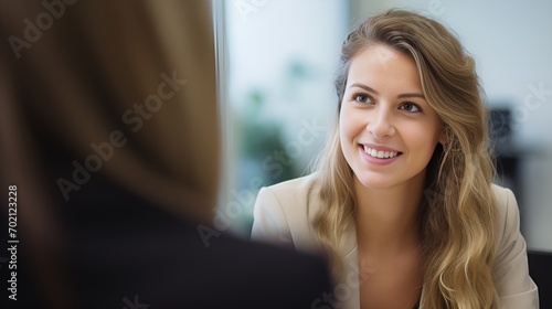Young female speaking with a client in the office , Young female, speaking with client, office