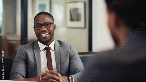 Young male speaking with a client in the office , Young male, speaking with client, office