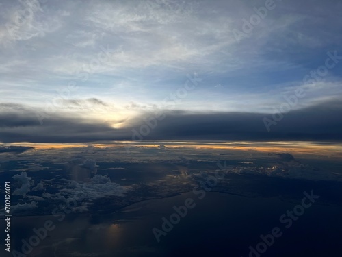 Sunrise above clouds from airplane window