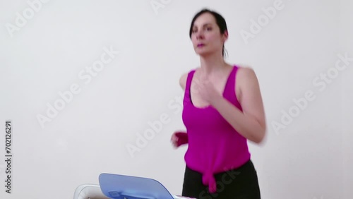 Wallpaper Mural Young Woman Exercises and Keeps Fit on a Treadmill, Video Clip 4K Torontodigital.ca